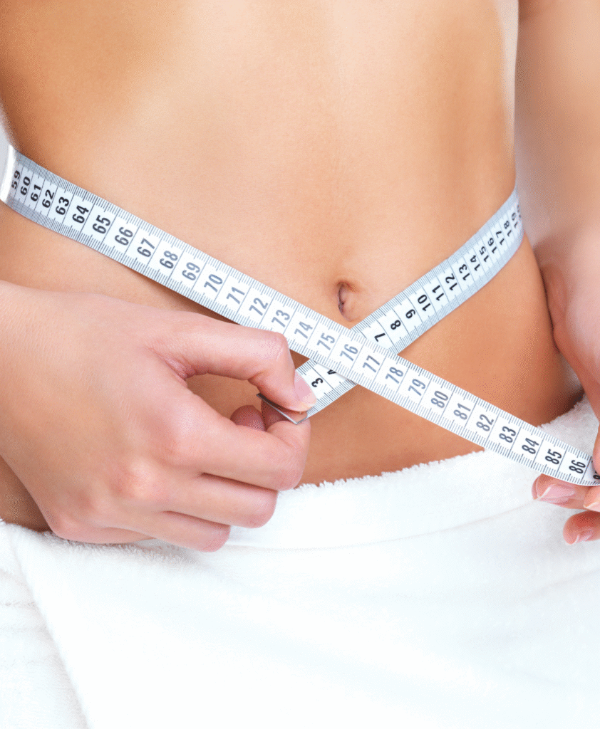 holding measuring tape around stomach